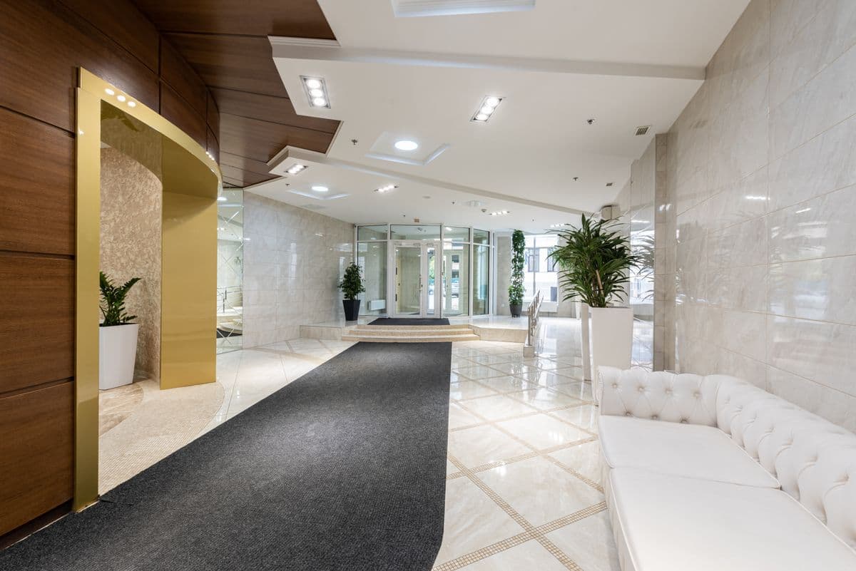 Hotel lobby with marble floors and lounge seating