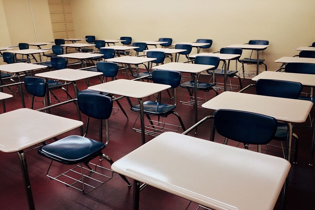 Classroom with rows of student desks and chairs