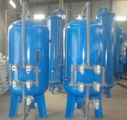 Row of blue pressure vessels for an industrial water softening plant